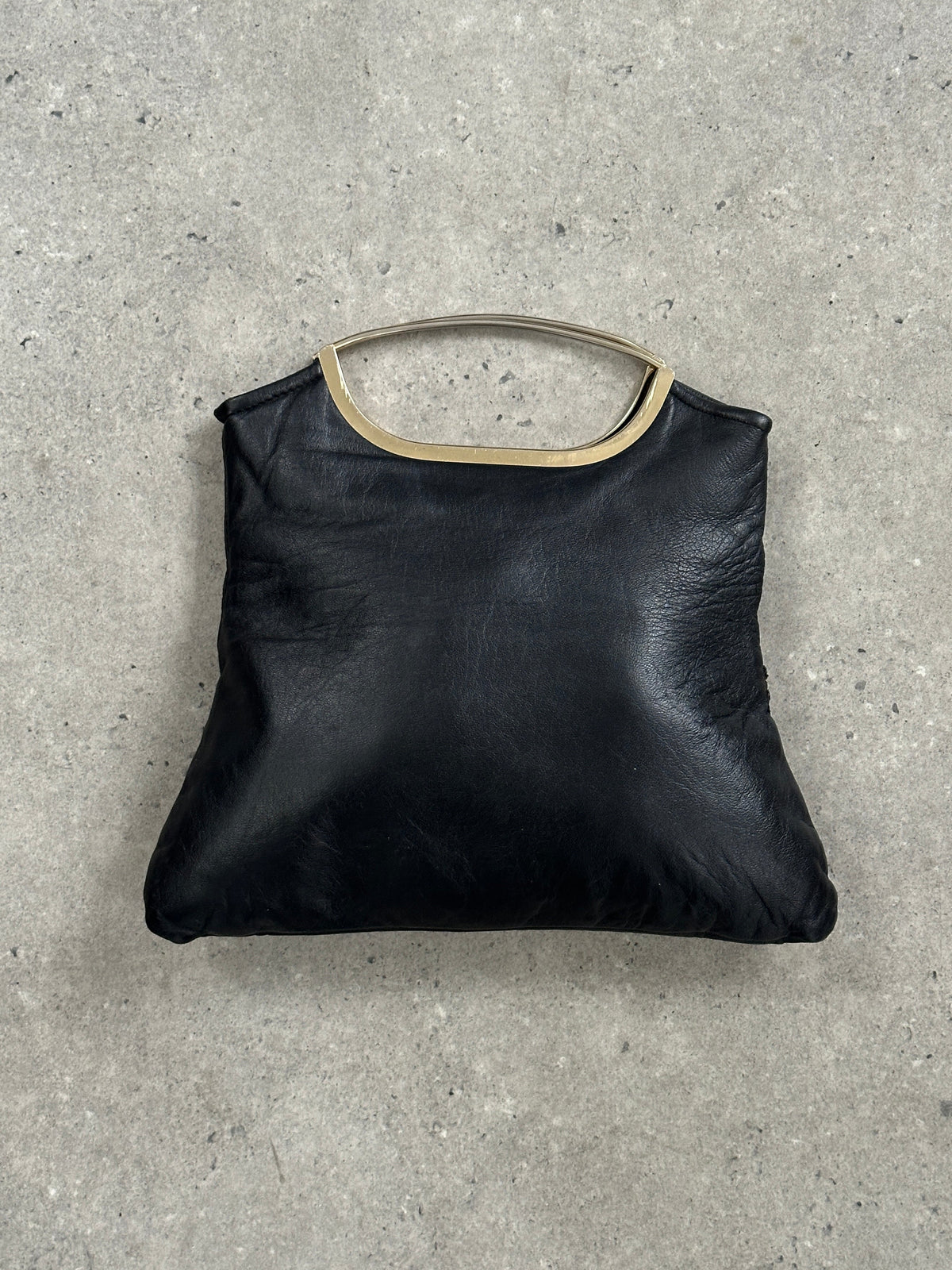 Vintage 1990s leather handbag with a classic design, featuring a structured shape and elegant leather finish, perfect for vintage style.