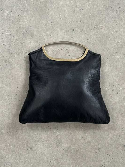 Vintage 1990s leather handbag with a classic design, featuring a structured shape and elegant leather finish, perfect for vintage style.