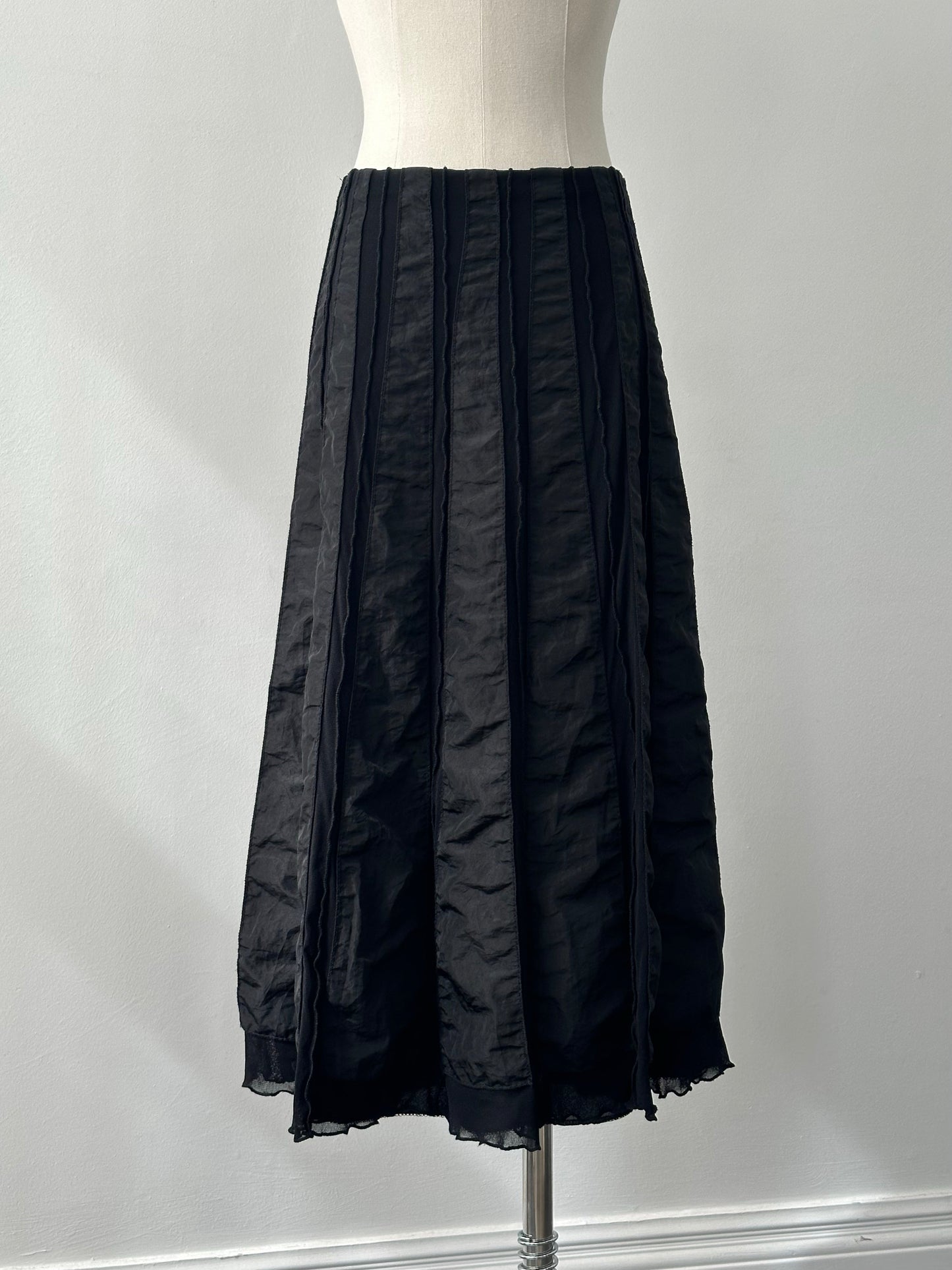 Vintage Italian satin-paneled midi skirt from the 1990s, with a waist size adjustable between W28 and W32, showcasing elegant fabric and design.