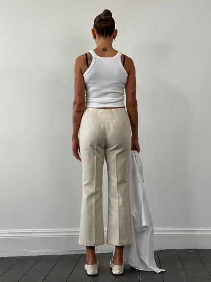 Vintage 1990s linen high waist cropped trousers, W26, shown flat with front pockets and relaxed fit, in natural beige color.