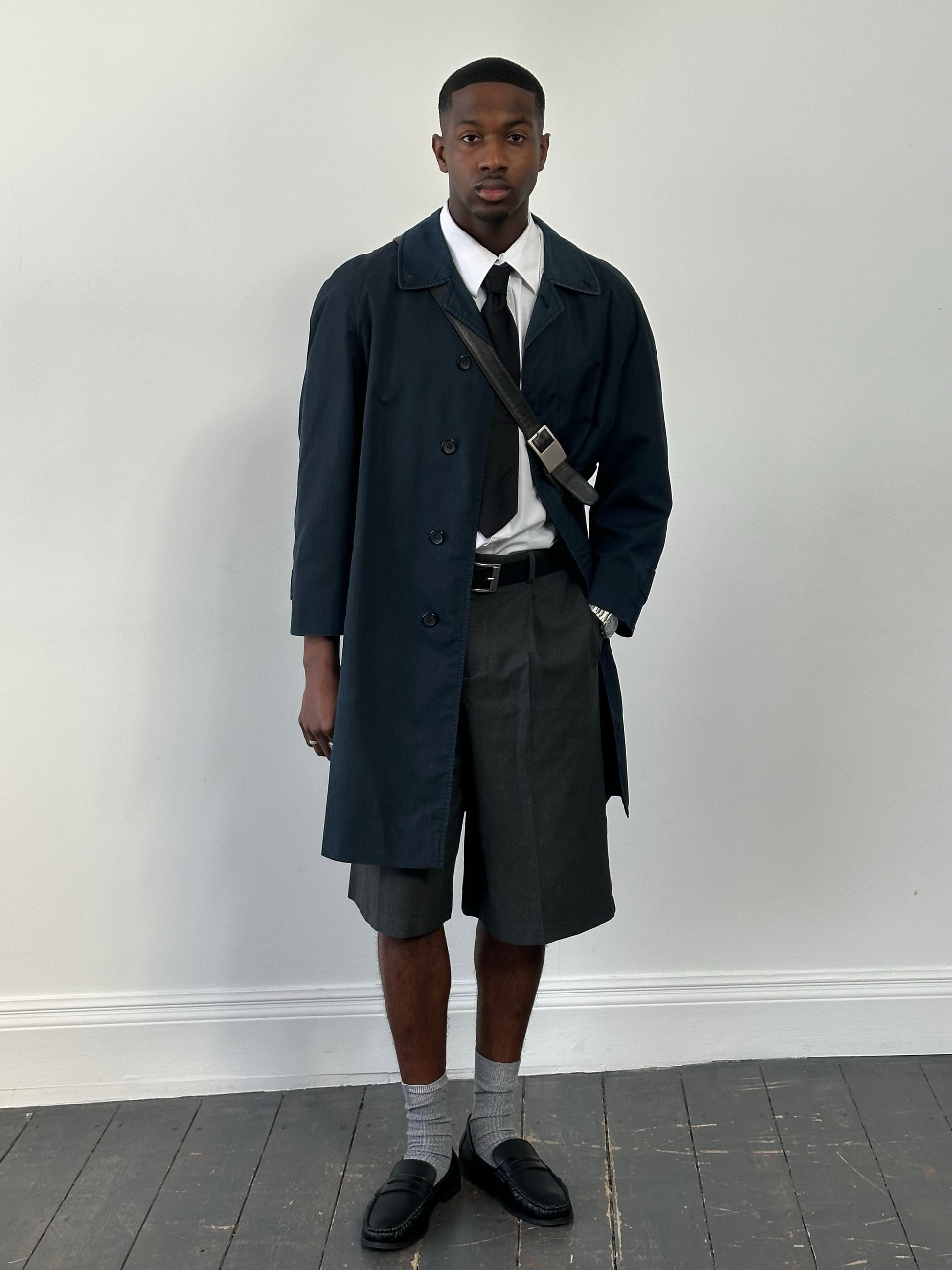 Burberry 1990s high neck trench coat with concealed placket in beige, displayed on a mannequin, showcasing classic design and high-quality fabric.