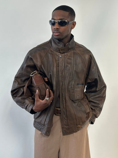 Vintage 1990s leather bomber jacket with high neck, displayed in size XL, showcasing classic retro style and high-quality leather material.