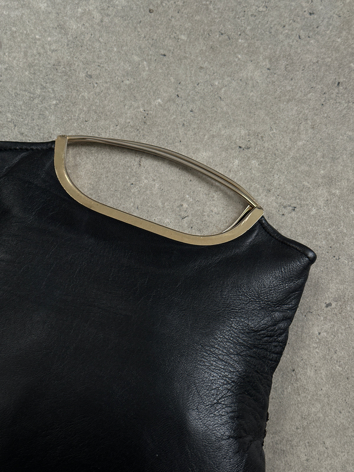 Vintage 1990s leather handbag with classic design, featuring a structured shape and vintage brand accents.