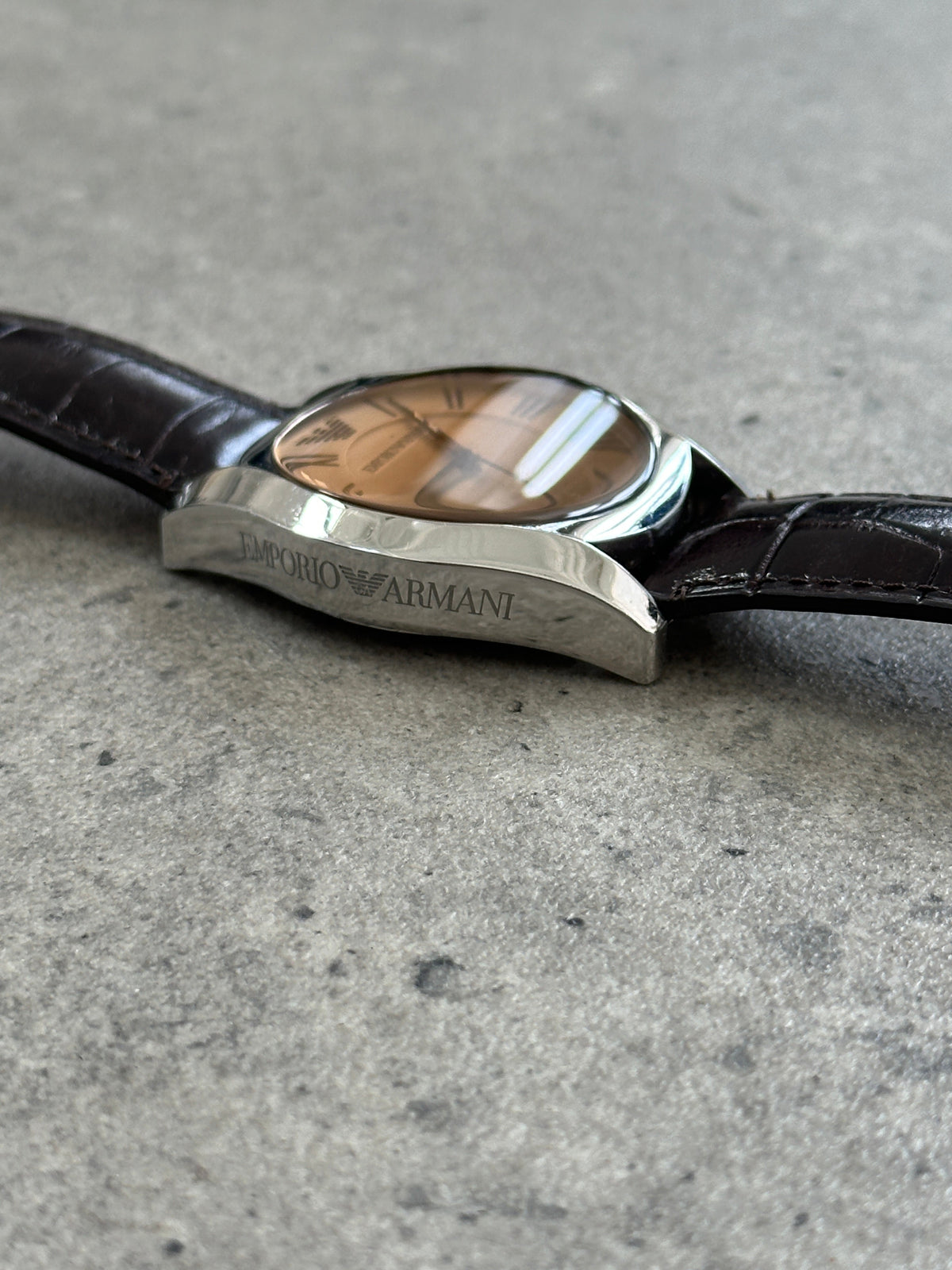 Emporio Armani leather quartz watch from the 2000s with a sleek design and classic round dial, showcasing elegant craftsmanship.