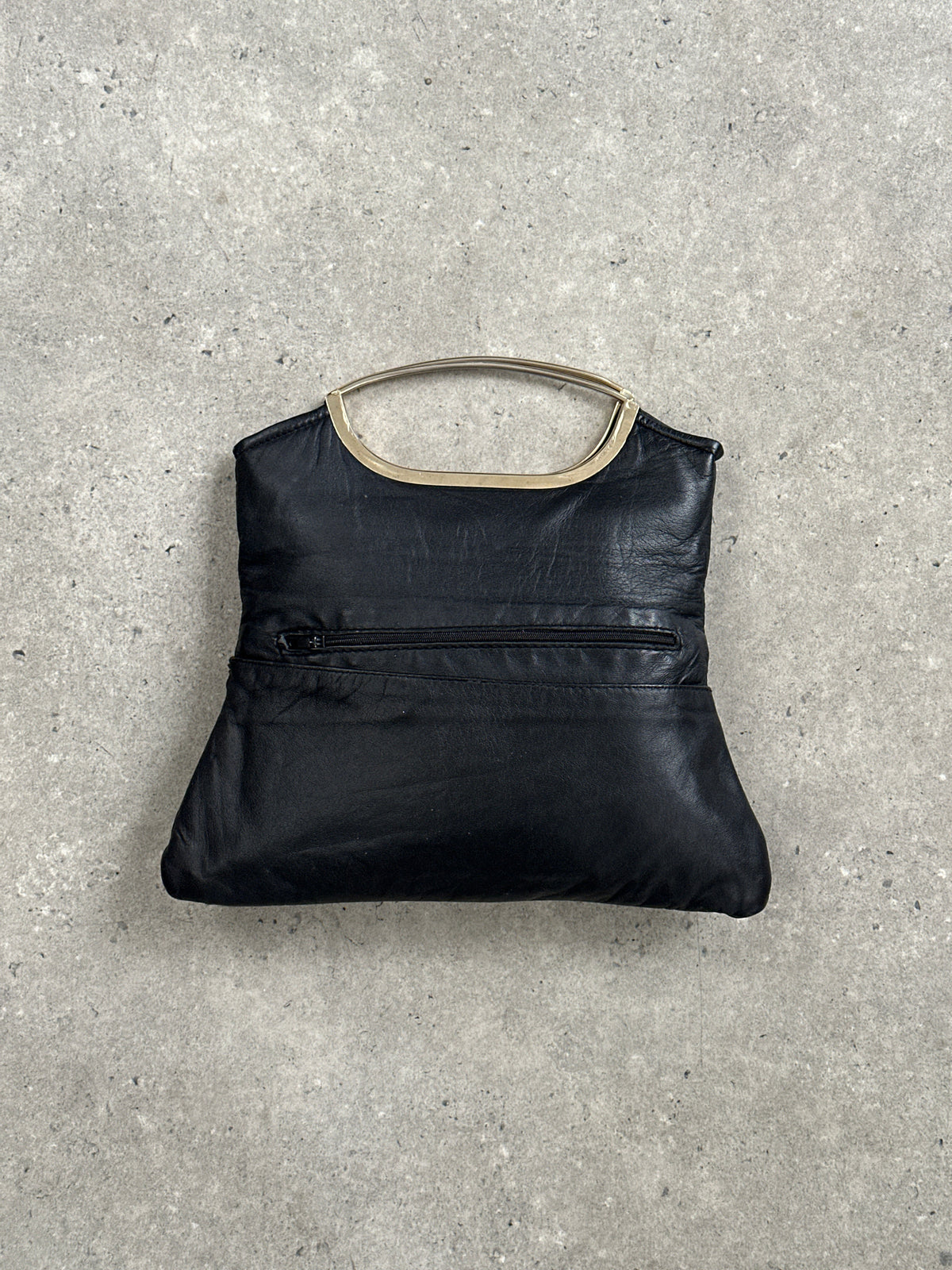 Vintage 1990s leather handbag with classic design, featuring a structured shape and vintage-style leather strap.