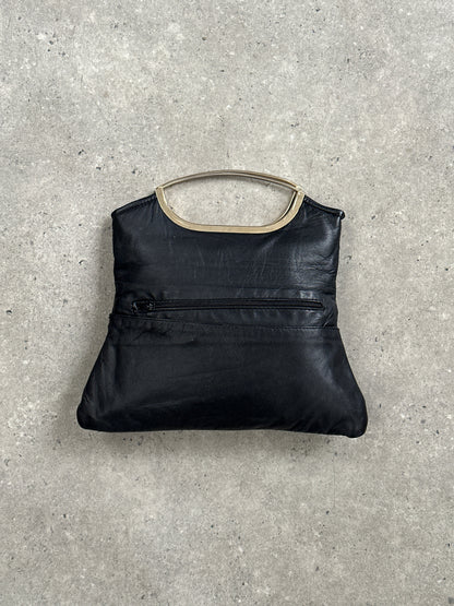 Vintage 1990s leather handbag with classic design, featuring a structured shape and vintage-style leather strap.