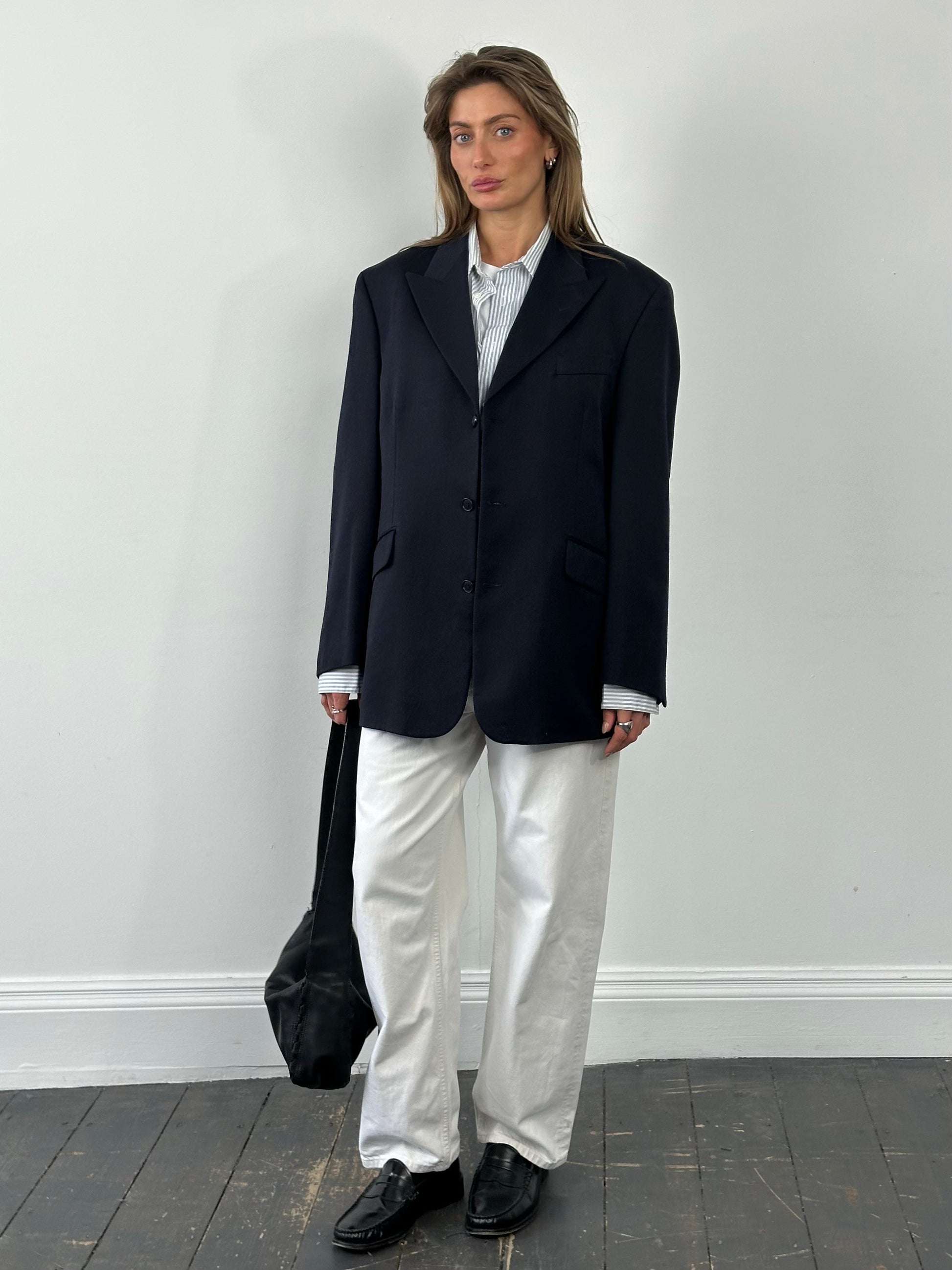 Yves Saint Laurent Pour Homme 1990s pure wool single-breasted blazer in size L/XL, shown on a hanger, classic men's fashion style.