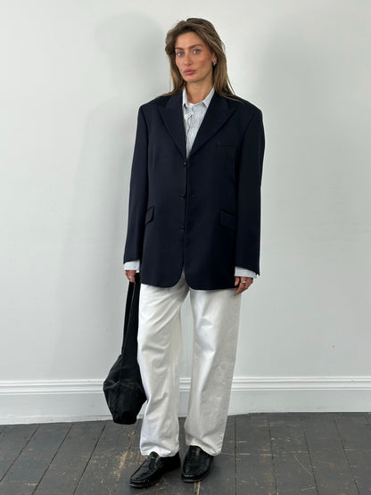Yves Saint Laurent Pour Homme 1990s pure wool single-breasted blazer in size L/XL, shown on a hanger, classic men's fashion style.