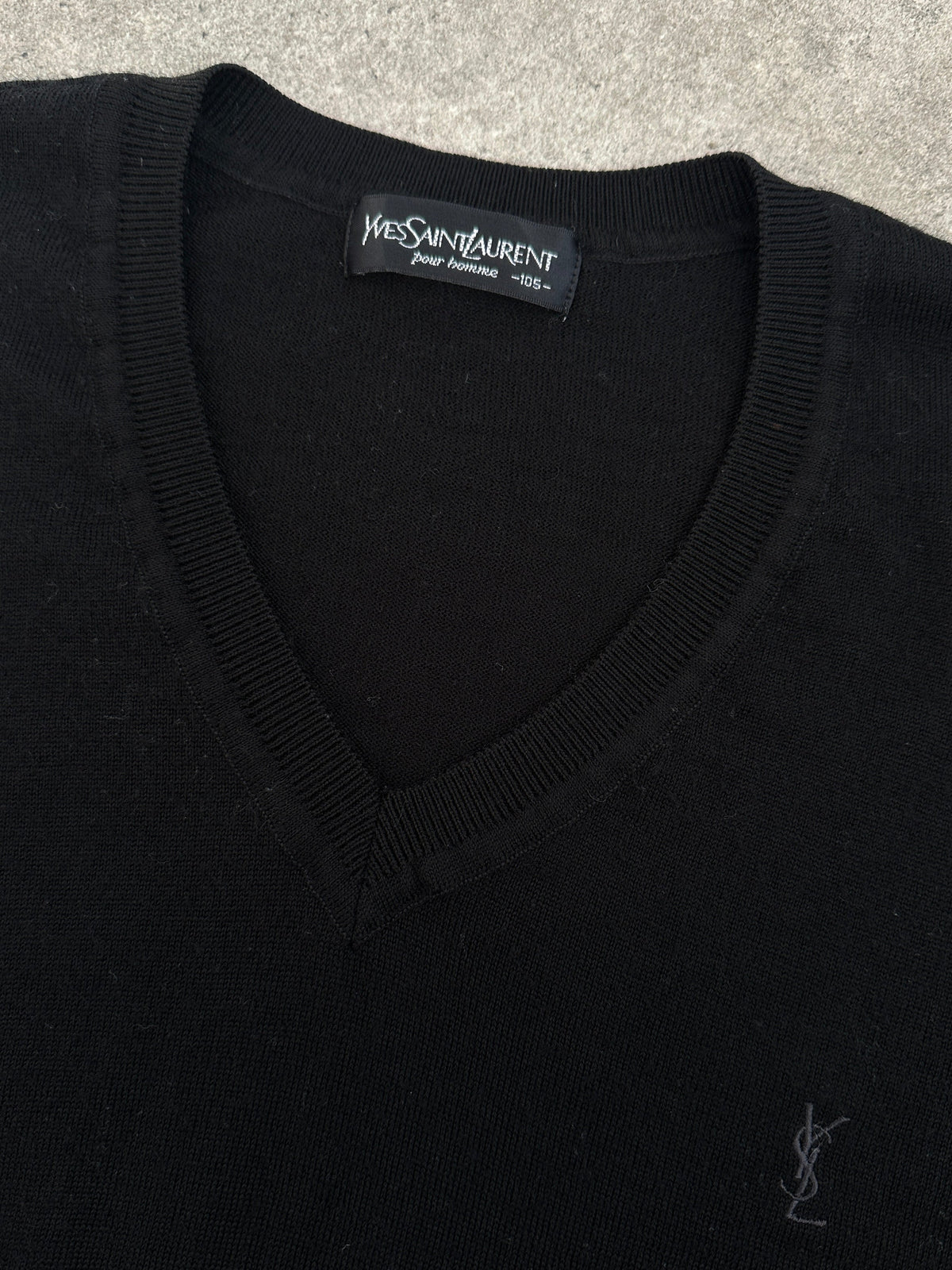 Yves Saint Laurent 1990s pure wool V-neck jumper in size M, shown in a close-up image highlighting the soft, textured fabric and classic design.