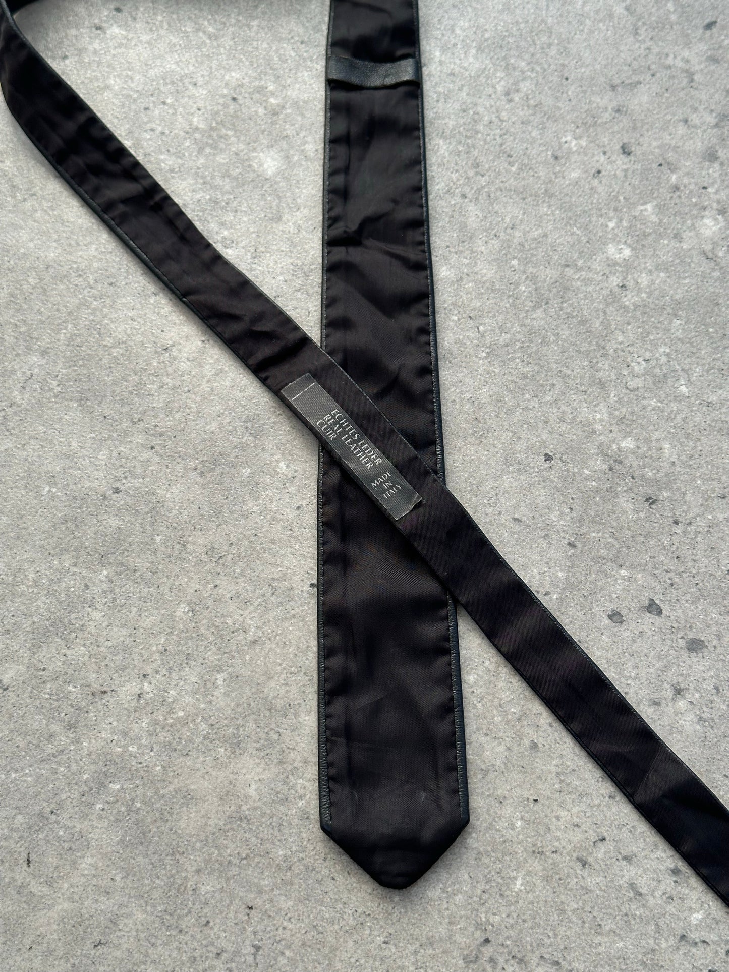 Vintage Italian 1990s slim leather tie with sleek design and rich brown color, perfect for sophisticated formal wear.