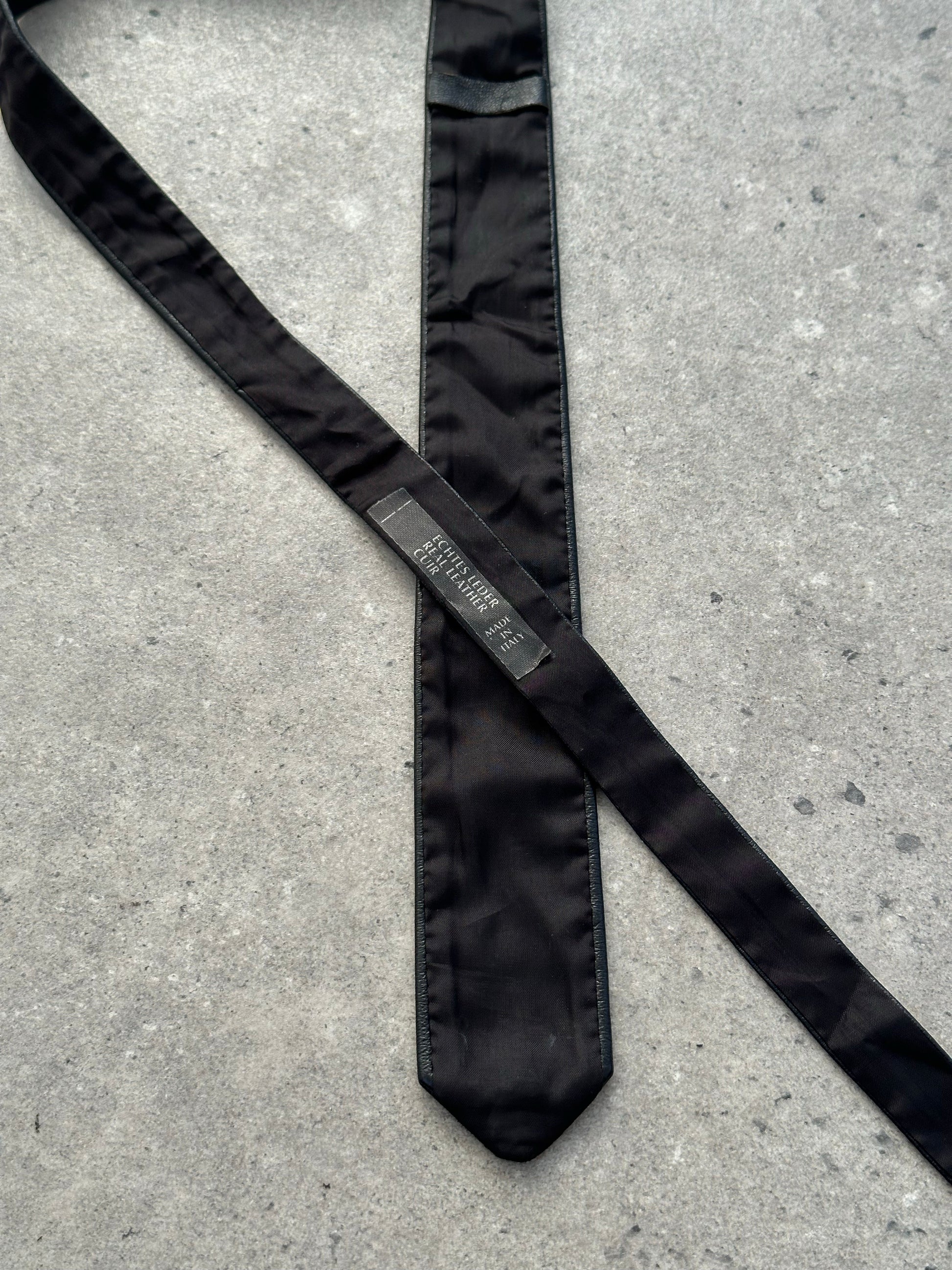 Vintage Italian 1990s slim leather tie with sleek design and rich brown color, perfect for sophisticated formal wear.