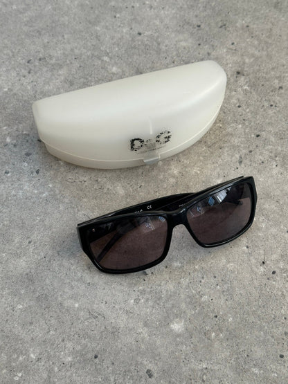 Dolce & Gabbana 2000s rectangle logo sunglasses with black frames and dark lenses on a white background.