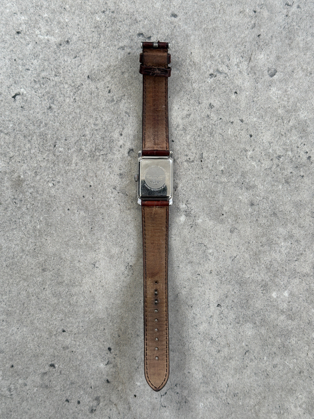 Emporio Armani 2000s leather rectangular quartz watch with silver dial and black leather strap, showcasing a classic fashion accessory.
