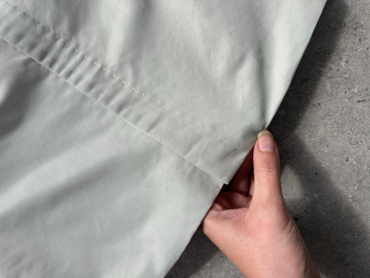 Gianfranco Ferre 1990s showerproof minimal jacket in size L, shown in a neutral color with a sleek, modern design.