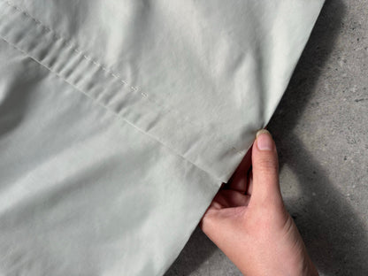 Gianfranco Ferre 1990s showerproof minimal jacket in size L, shown in a neutral color with a sleek, modern design.