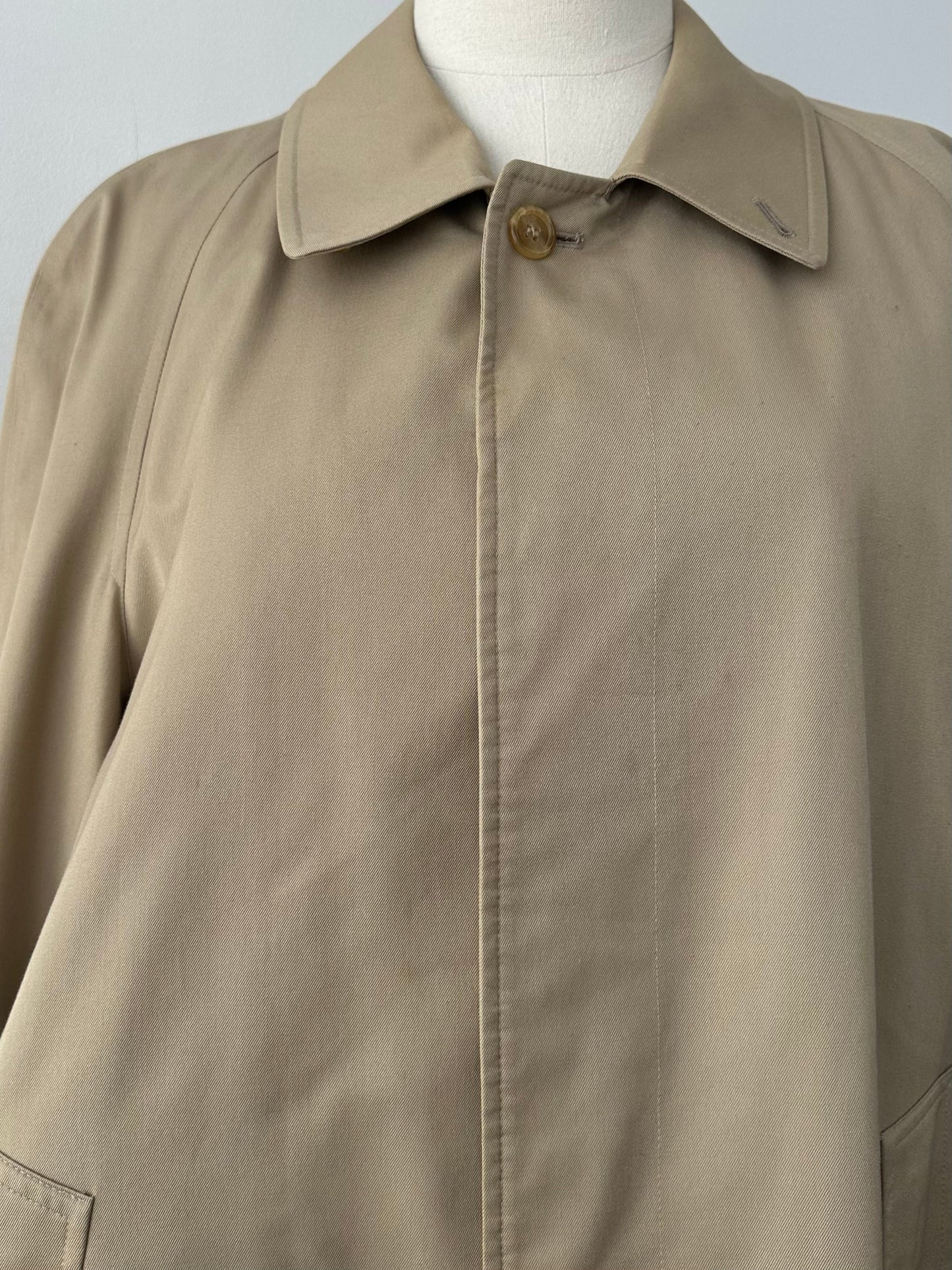 Burberry 1990s pure cotton high-neck trench coat in beige, displayed on a hanger, showcasing classic design and quality craftsmanship.