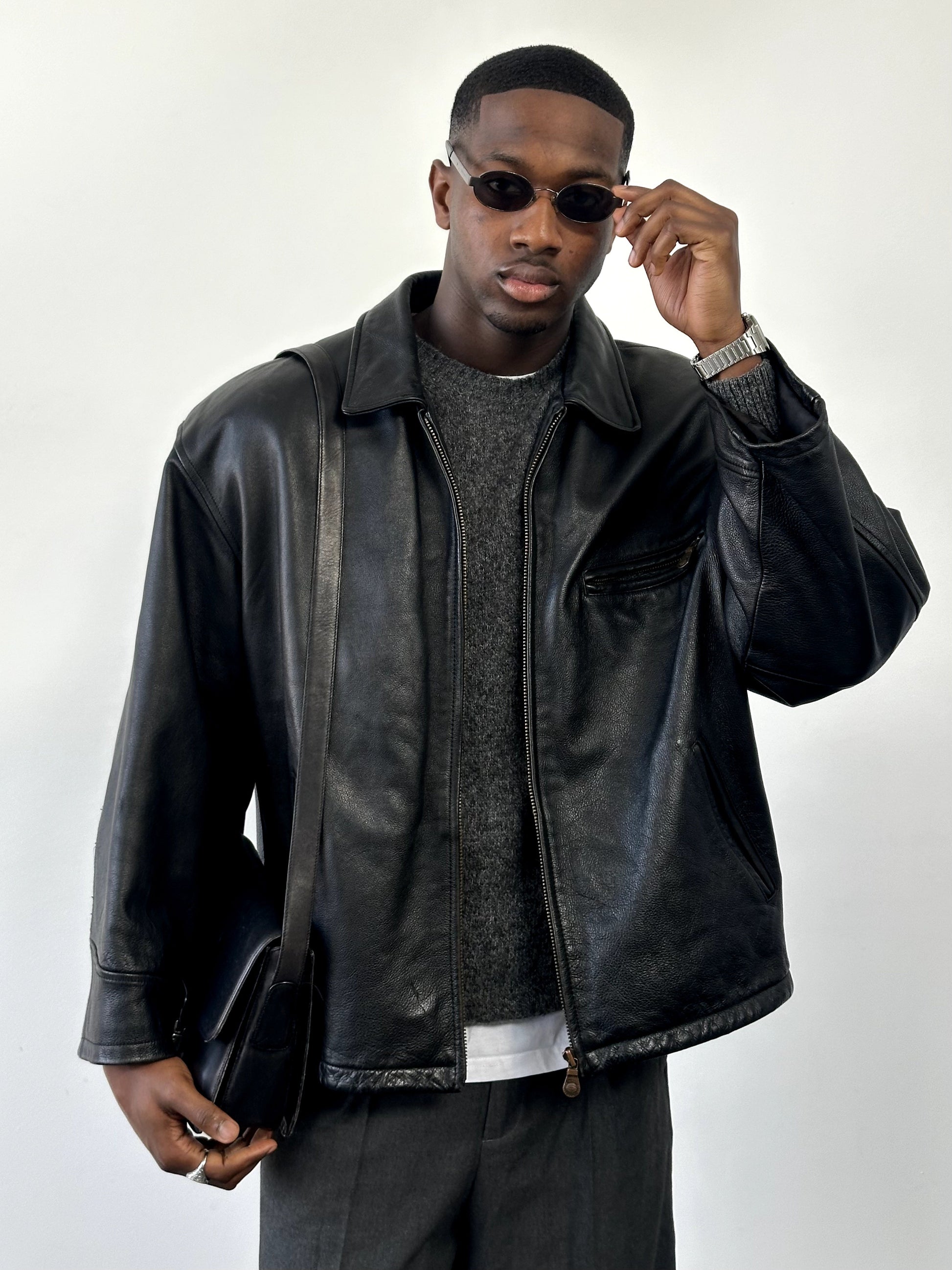 Vintage 1990s heavyweight leather jacket in XXL, minimal design, black leather with classic collar and front zipper.