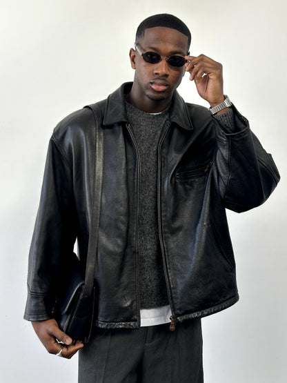 Vintage 1990s heavyweight leather jacket in XXL, minimal design, black leather with classic collar and front zipper.