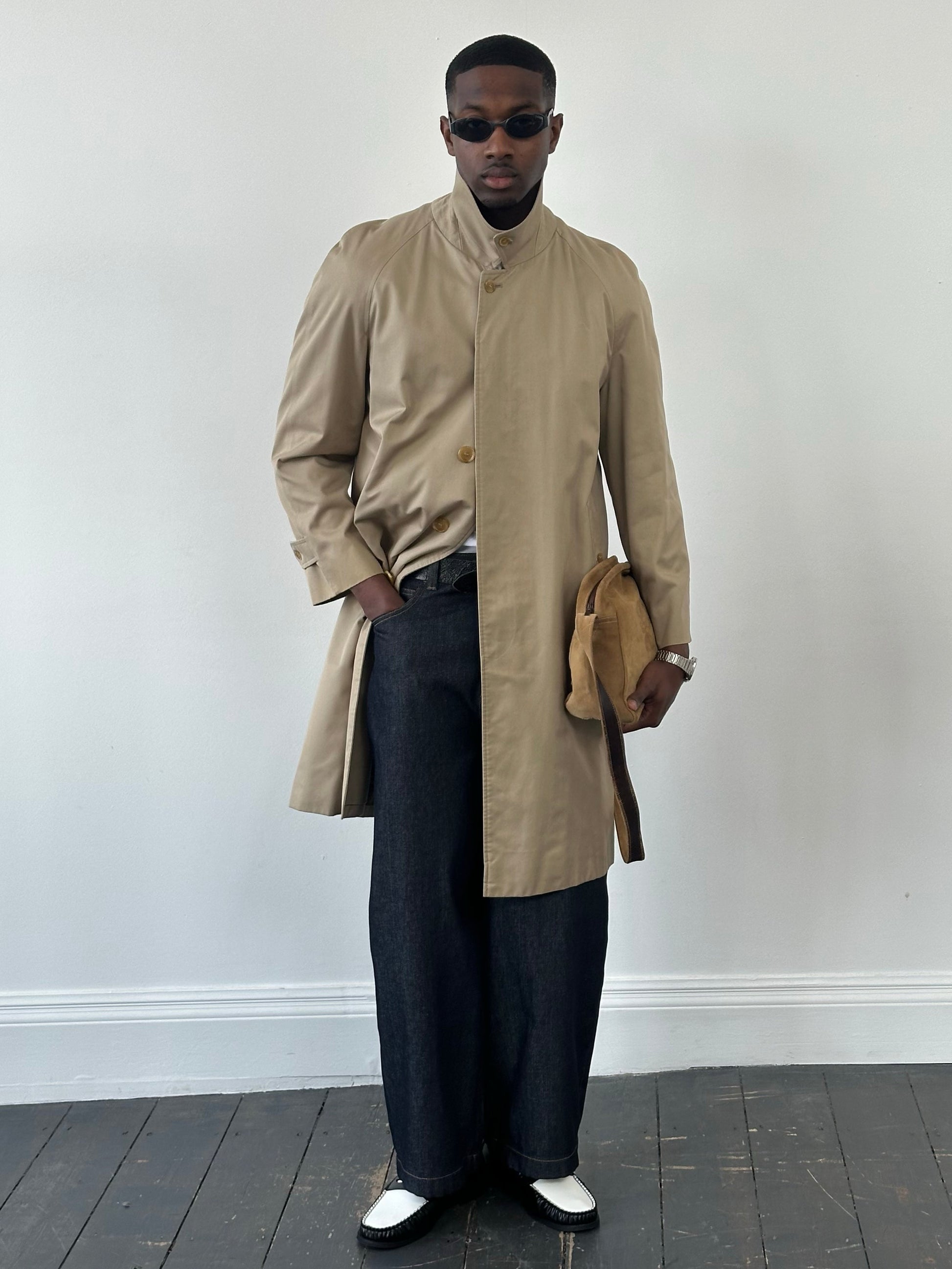 Burberry 1990s pure cotton high neck trench coat in beige, displayed on a hanger with details of the collar and fabric texture visible.