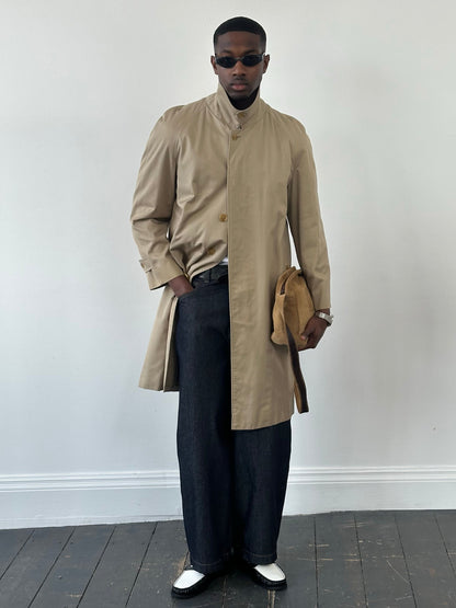 Burberry 1990s pure cotton high neck trench coat in beige, displayed on a hanger with details of the collar and fabric texture visible.