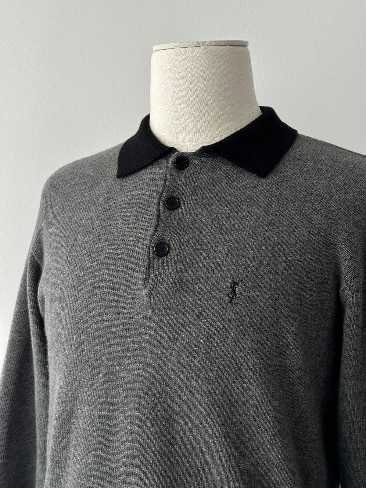 Yves Saint Laurent 1990s wool polo jumper in black, featuring a classic collar and ribbed cuffs, size S-M.
