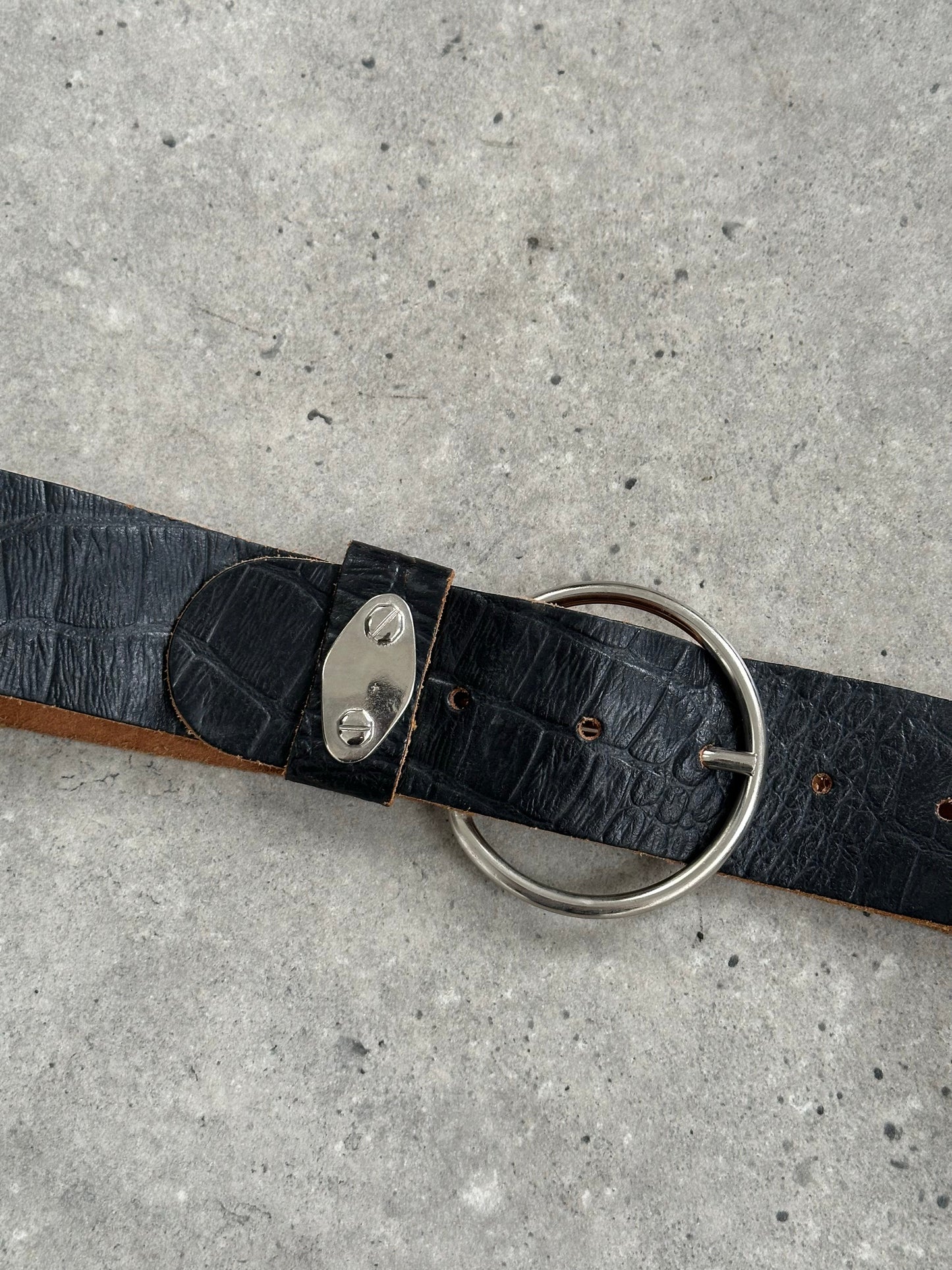Vintage 1990s circular leather chunky belt with bold design, featuring a large circular buckle and distressed leather finish.