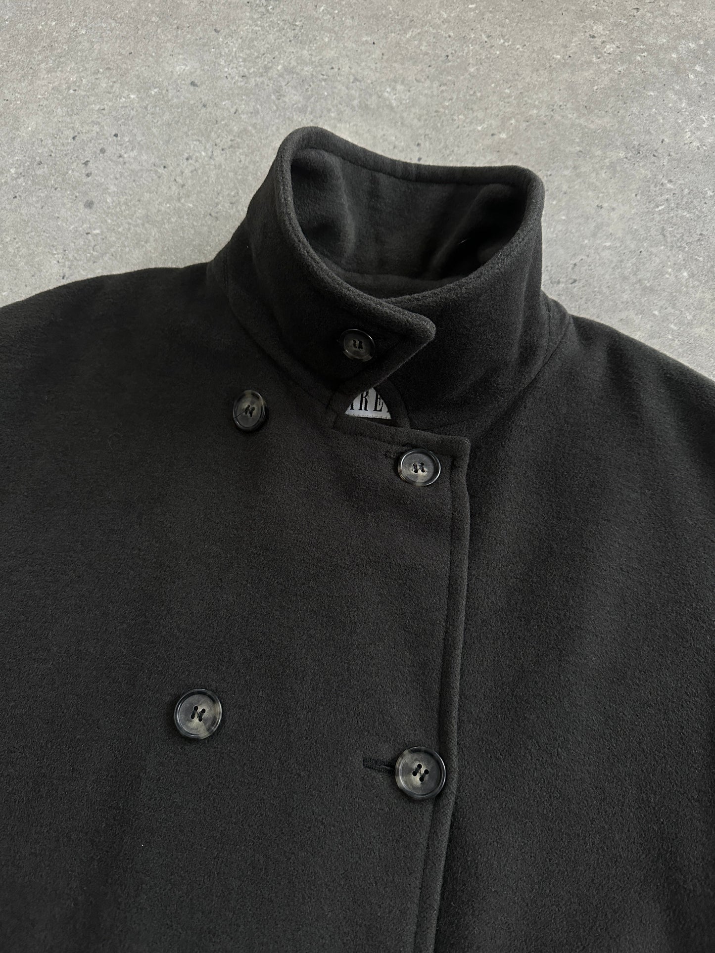 Marella 1990s virgin wool double-breasted coat in size L/XL displayed on a hanger, showcasing classic style and tailored fit.