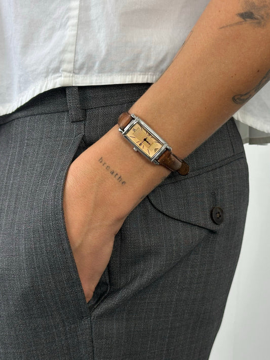Emporio Armani 2000s leather watch with round dial, silver-tone case, and brown leather strap, showcasing classic luxury style.