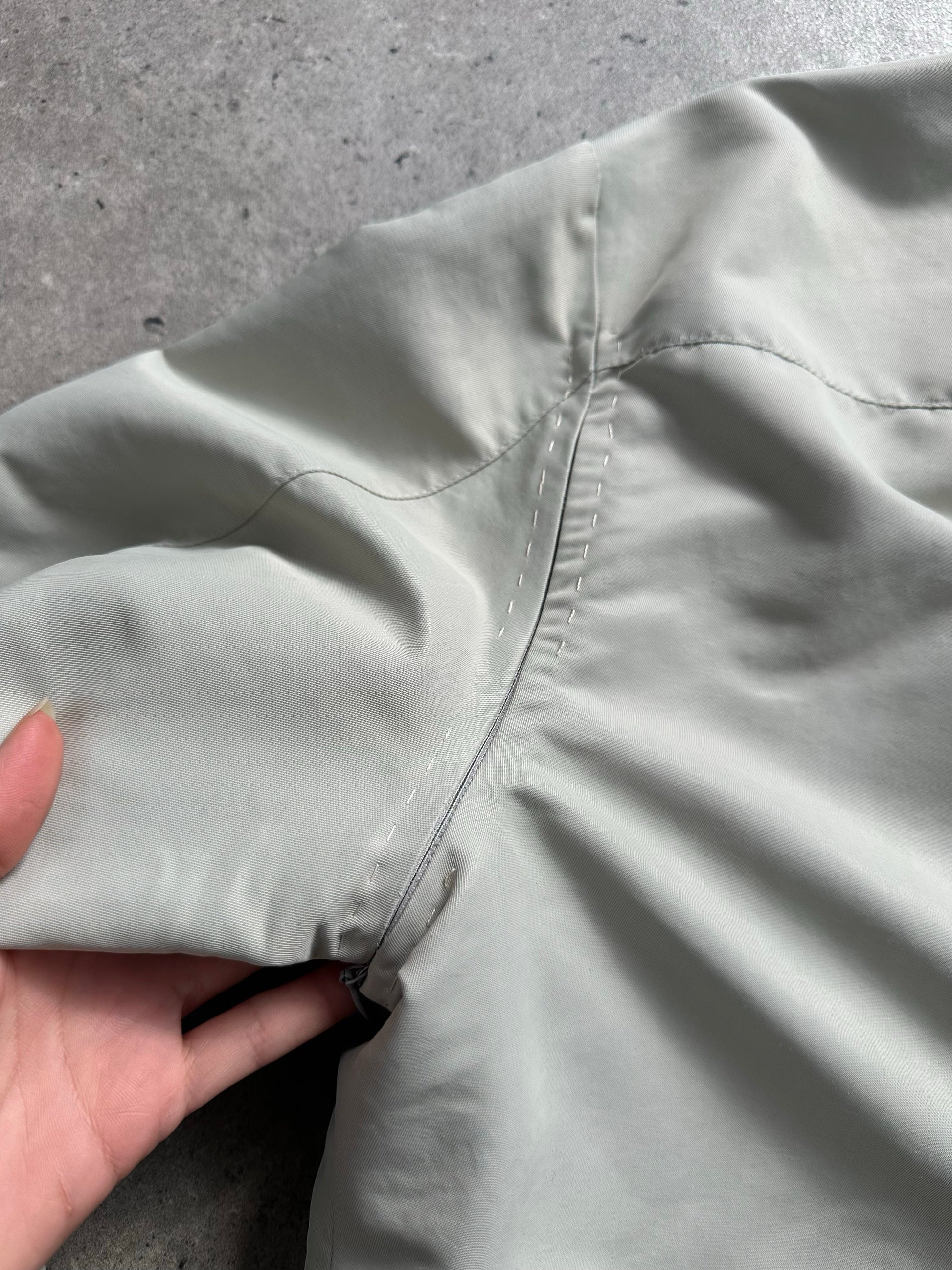 Gianfranco Ferre 1990s showerproof minimal jacket in size L, lightweight jacket with sleek design and waterproof fabric.