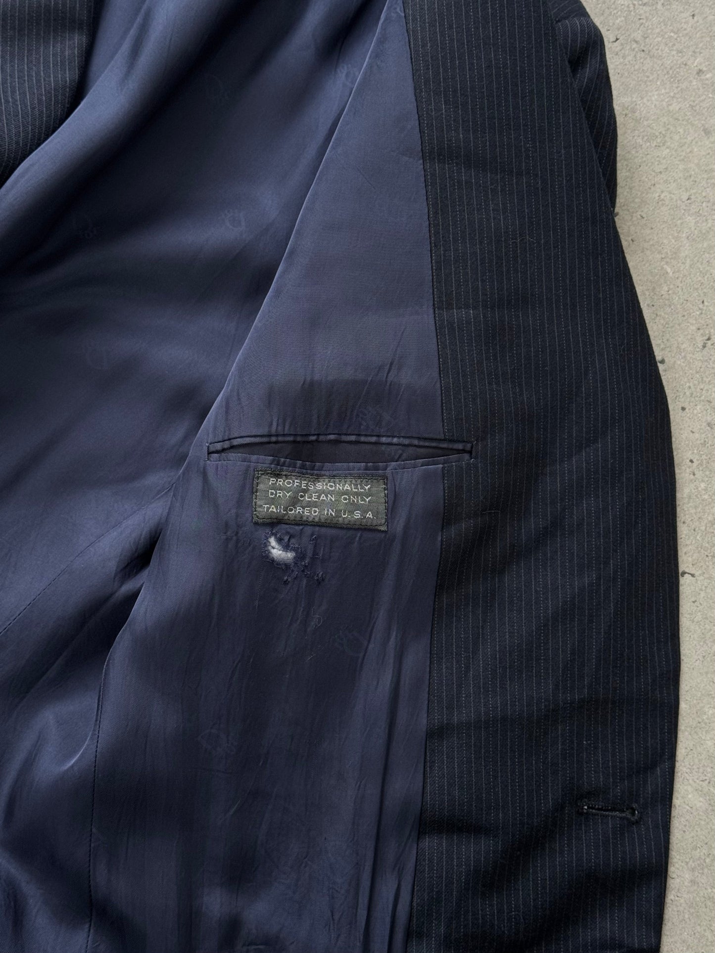 Christian Dior Monsieur 1980s wool striped blazer, size 40R, shown on a hanger with navy and gray striped fabric.