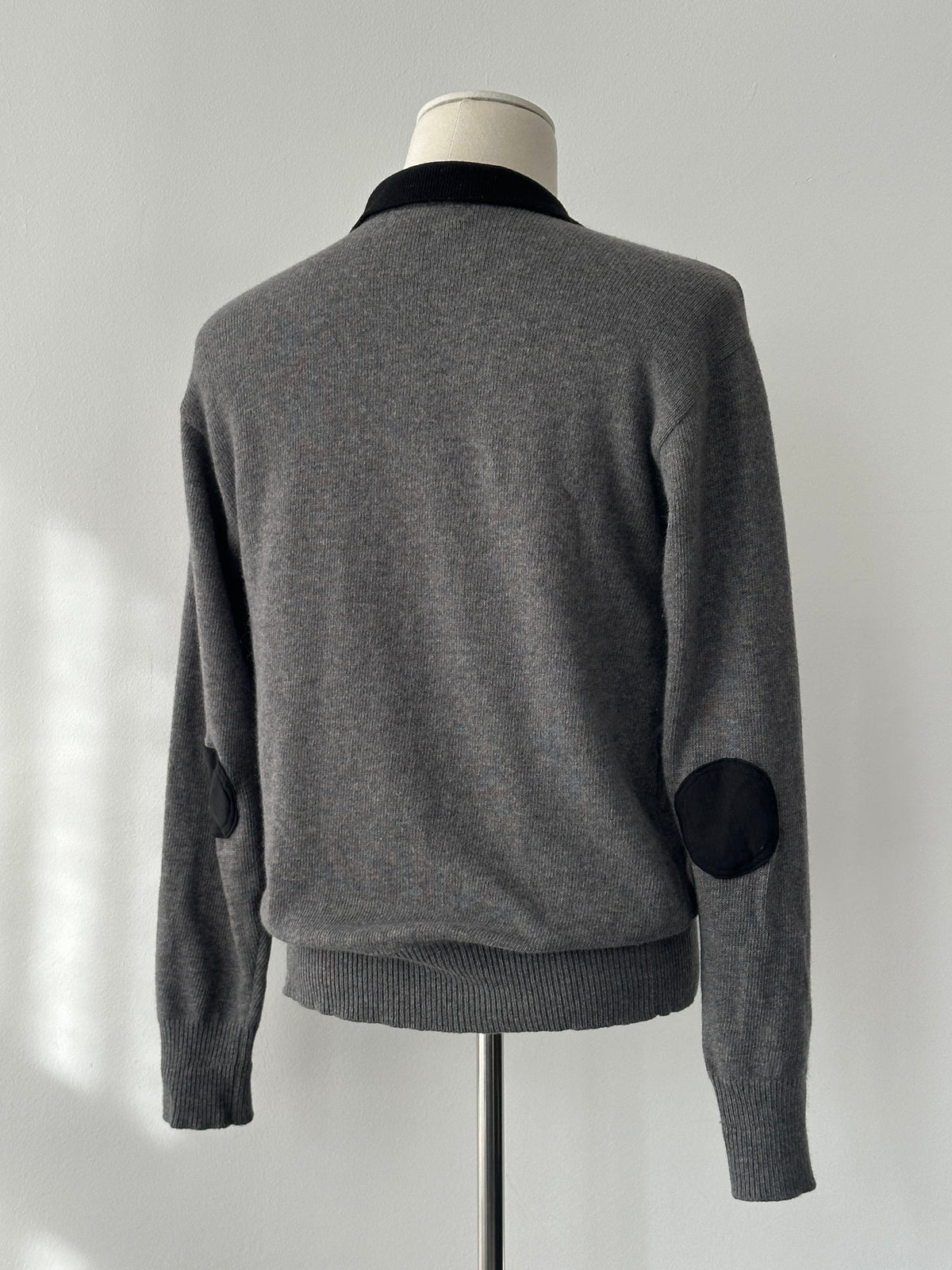Yves Saint Laurent 1990s wool polo jumper in navy, featuring classic collar and ribbed cuffs, size S-M, displayed on a mannequin.