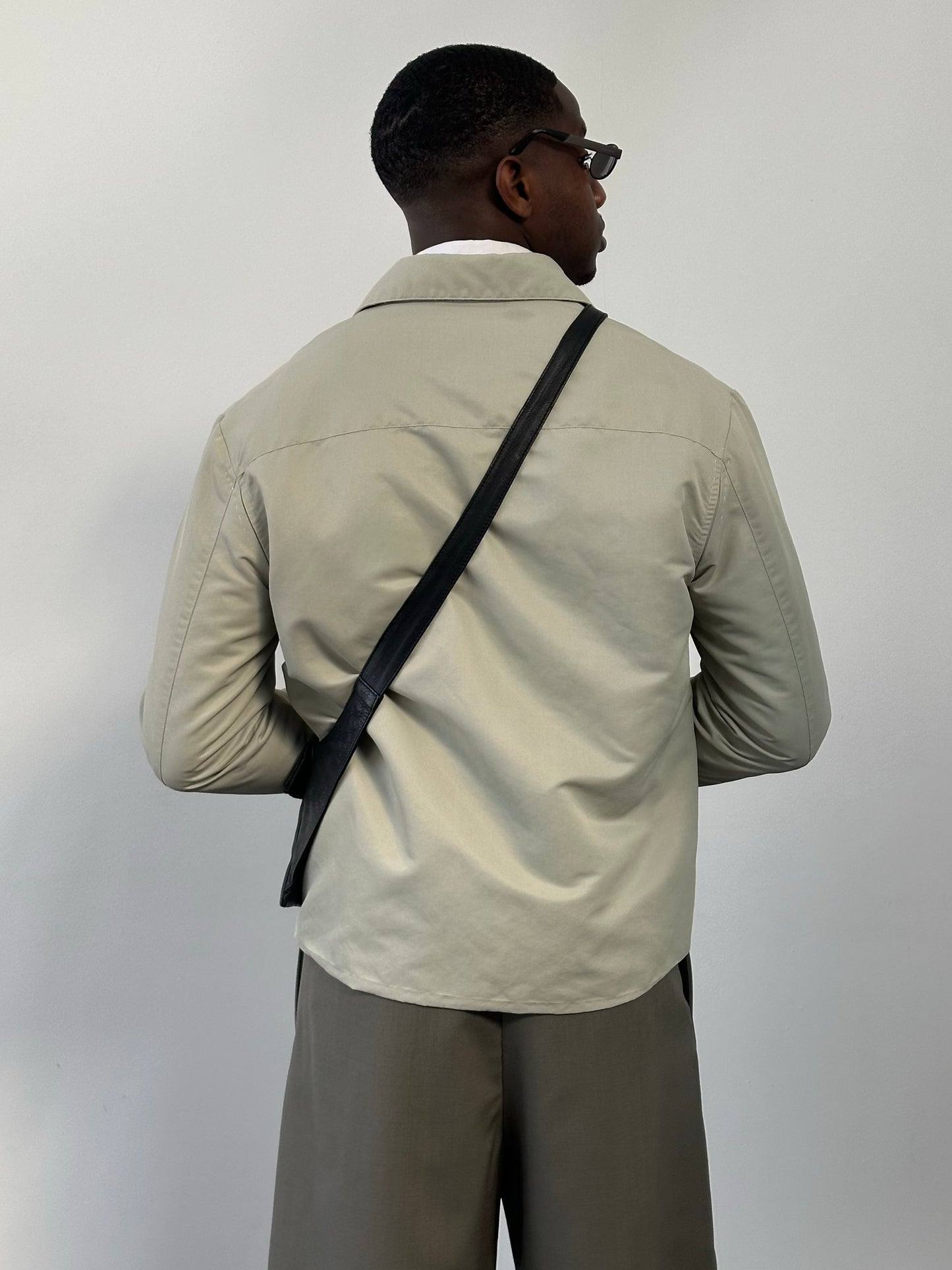 Gianfranco Ferre 1990s showerproof minimal jacket in size L, featuring sleek design and lightweight fabric, front view.