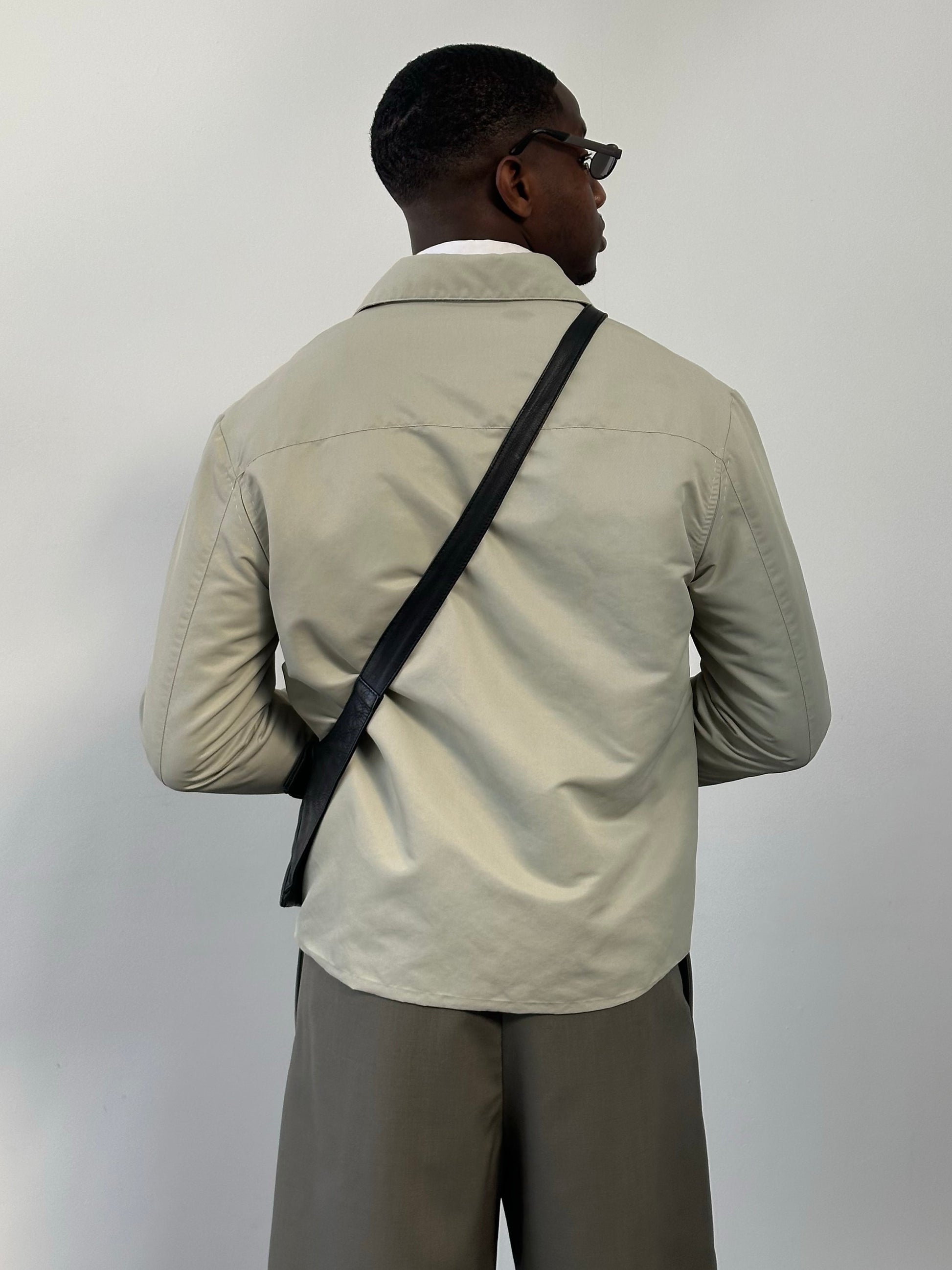 Gianfranco Ferre 1990s showerproof minimal jacket in size L, featuring sleek design and lightweight fabric, front view.