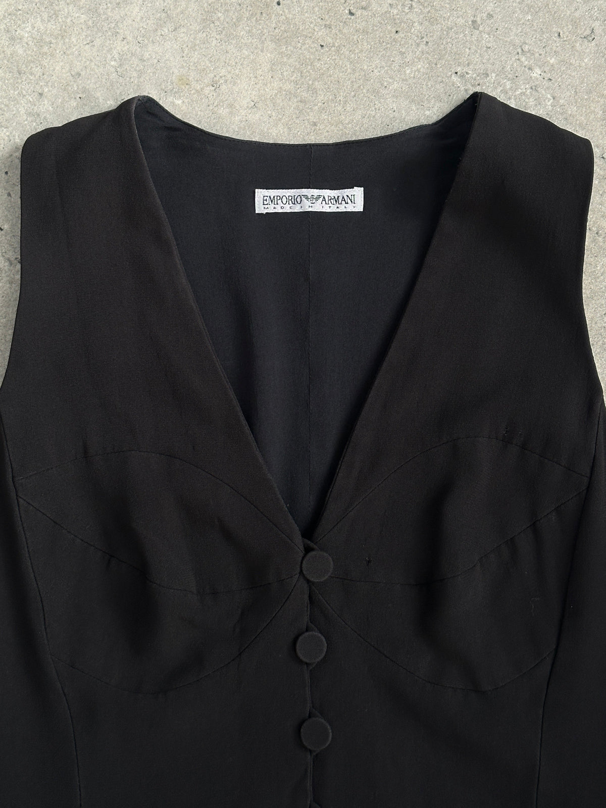 Emporio Armani 1990s fitted tailored single-button waistcoat in dark fabric, front view showing classic design and sleek silhouette.