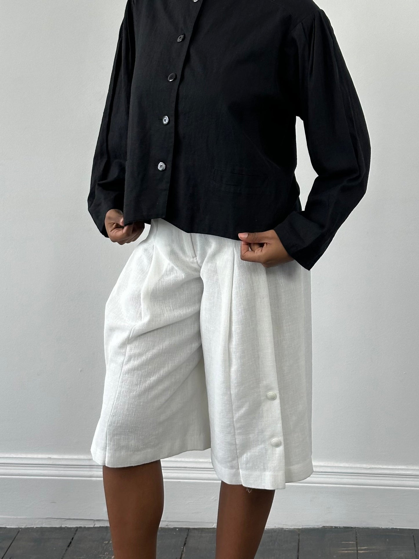 Vintage Japanese 1990s high-waisted pleated culottes shorts in a vintage style, W24-26, with a classic pleated design.