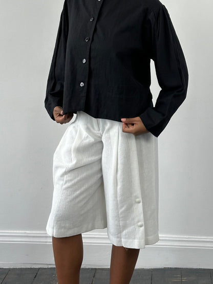 Vintage Japanese 1990s high-waisted pleated culottes shorts in a vintage style, W24-26, with a classic pleated design.