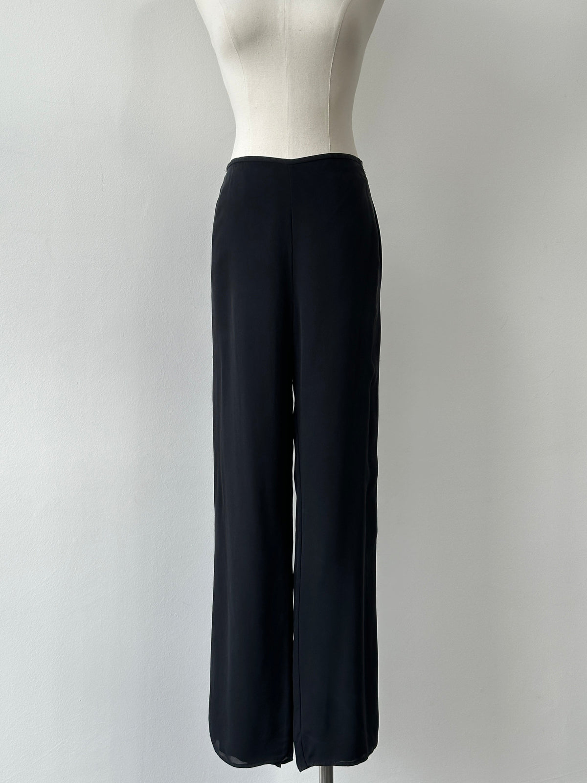 Vintage 1990s pure silk wide leg trousers, size W30, with flowing fabric and high waist, styled in a classic vintage design.