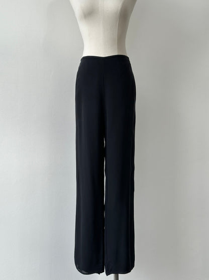 Vintage 1990s pure silk wide leg trousers, size W30, with flowing fabric and high waist, styled in a classic vintage design.