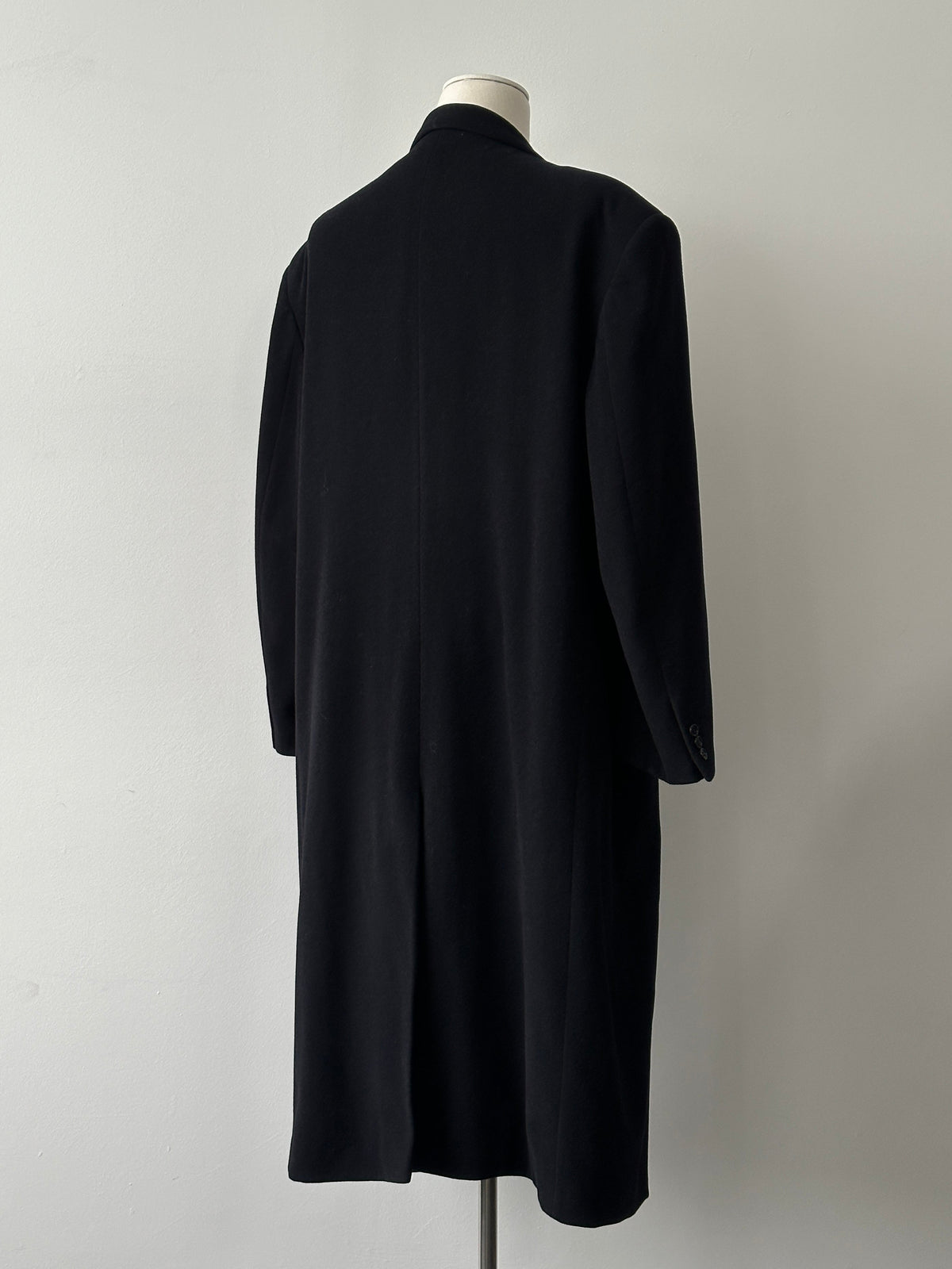 Pierre Cardin 1990s wool cashmere double-breasted coat in XXL, shown hanging on a wooden rack with classic design and tailored fit.