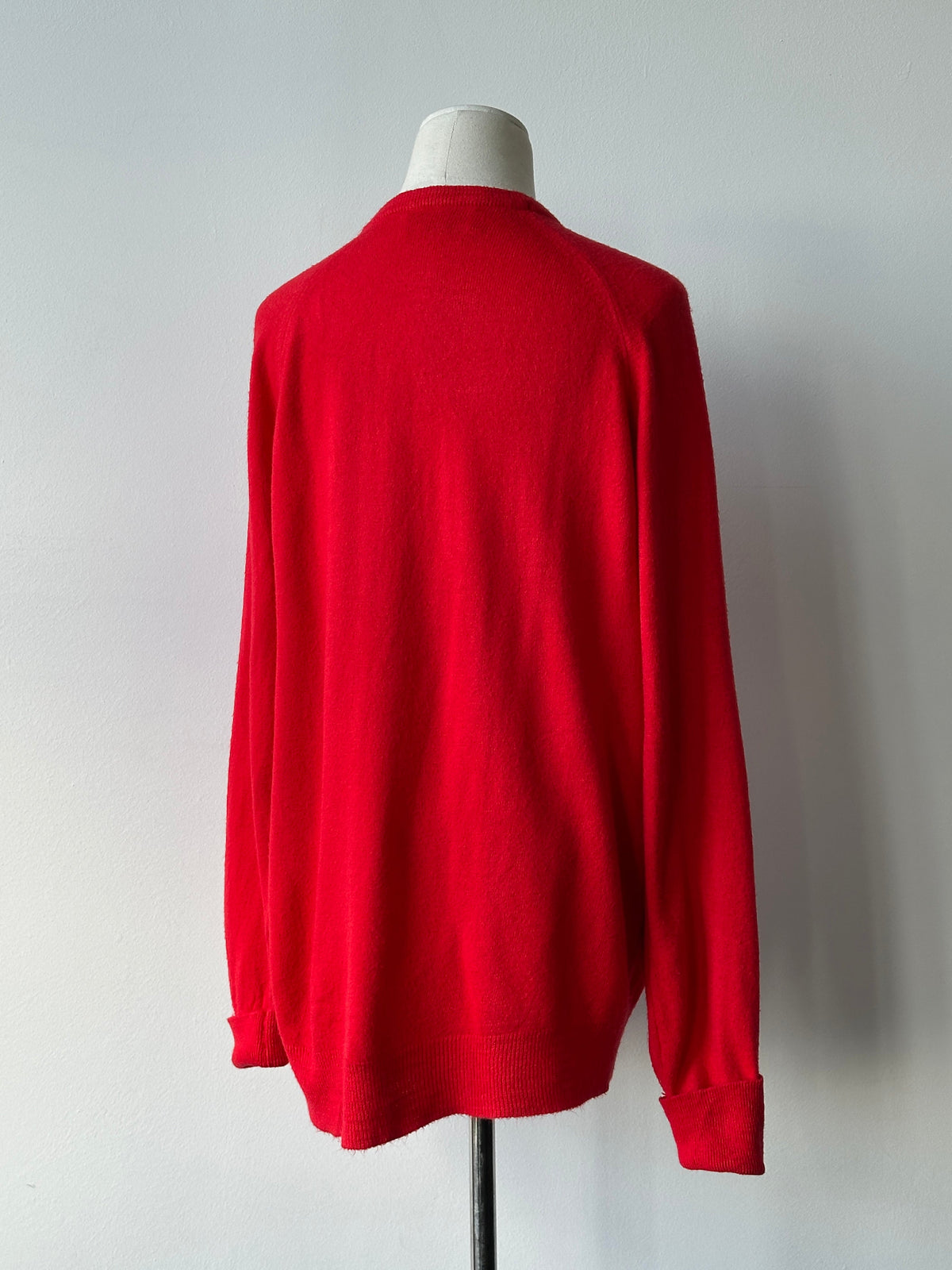 Christian Dior 1990s V-neck logo jumper in black, featuring the iconic Dior logo on the front, styled on a mannequin.