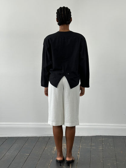 Vintage Japanese 1990s high-waisted pleated culottes shorts in a classic vintage style, with a relaxed fit and pleated design.