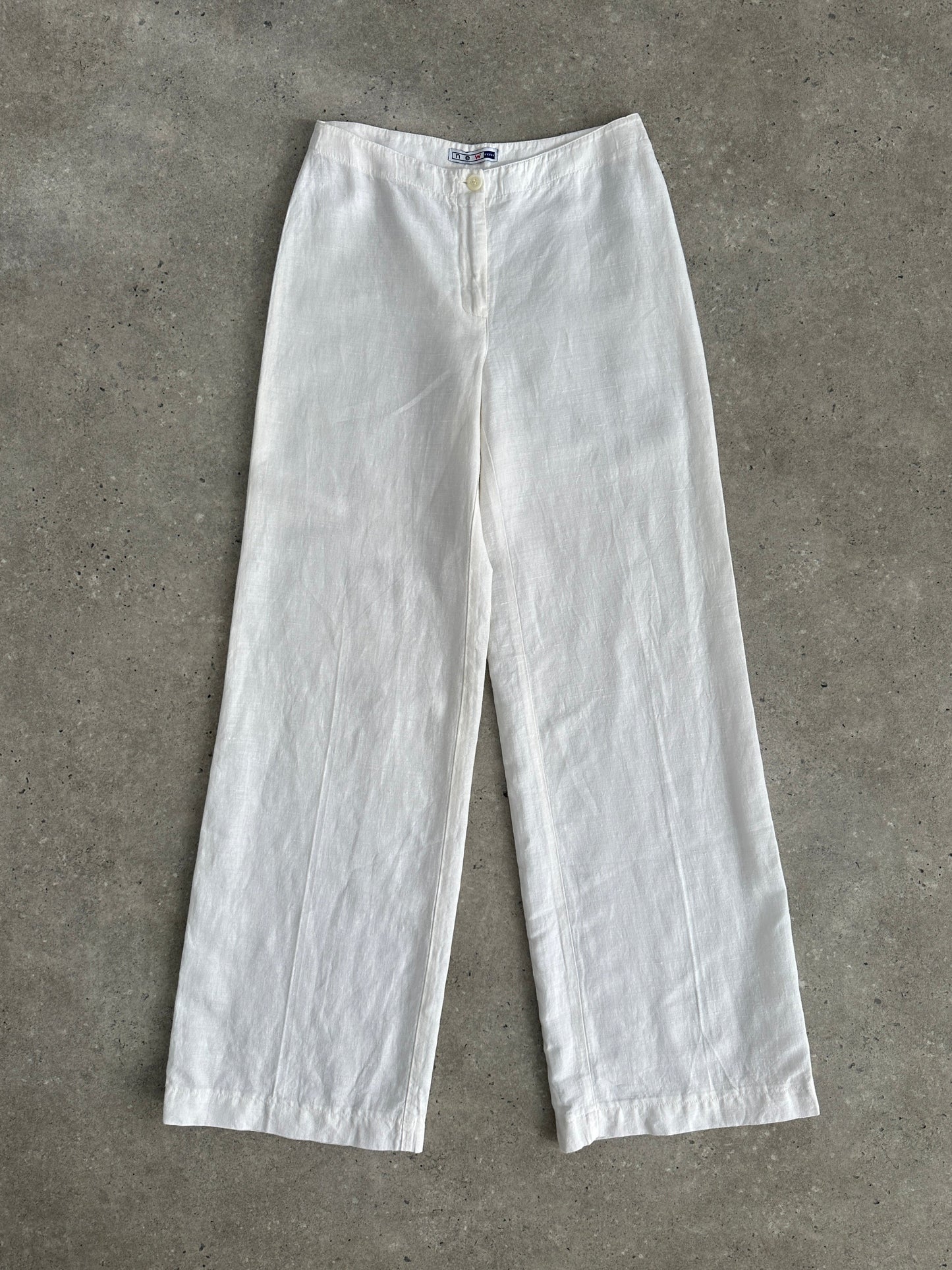 Vintage pure linen low waist wide-leg trousers with relaxed fit and natural fabric, shown on a hanger.