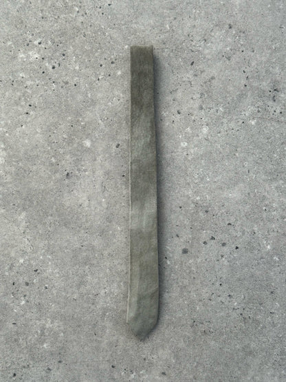 Vintage 1990s suede skinny tie with a narrow style and soft texture, featuring a classic design suitable for retro fashion.