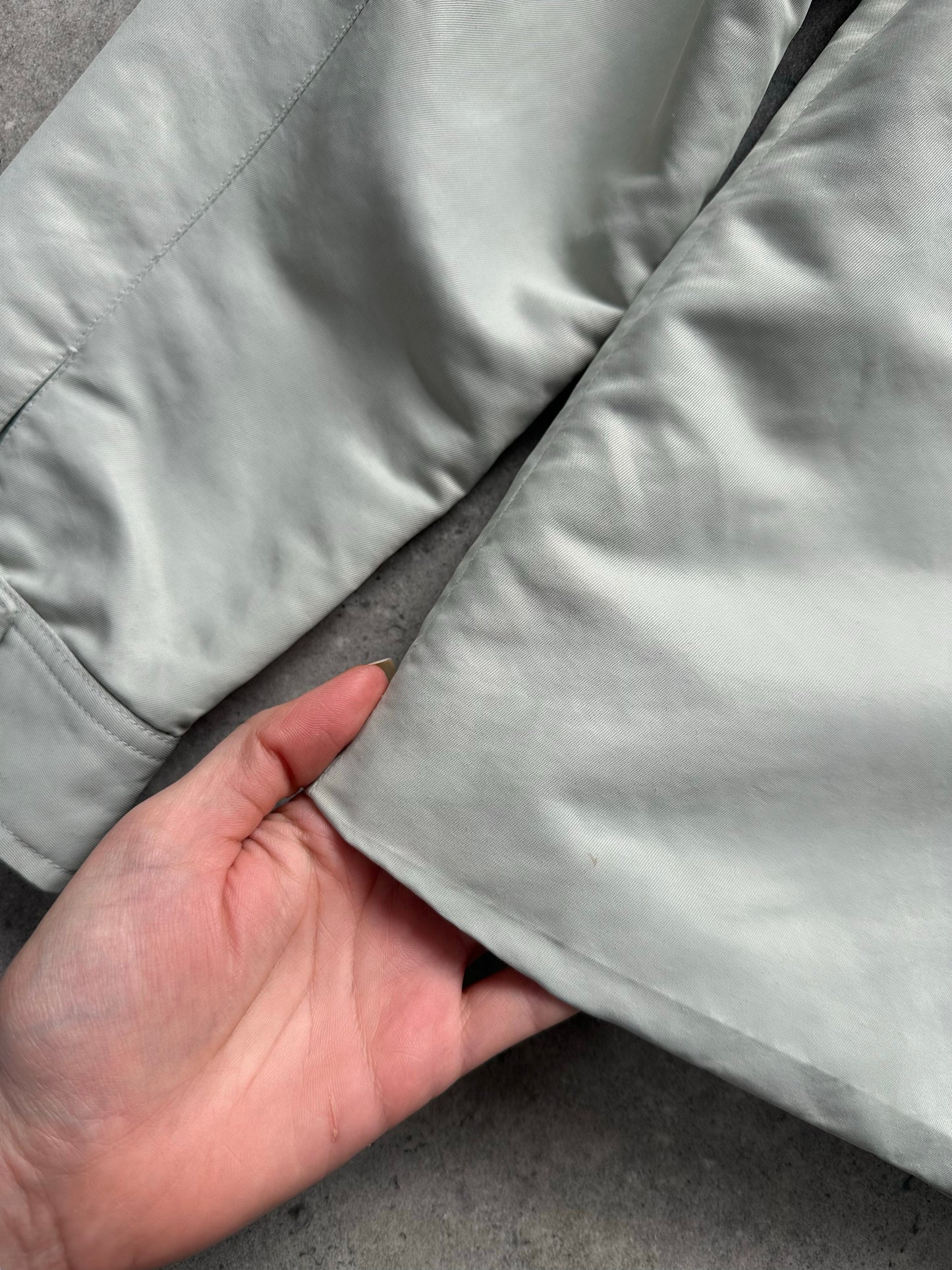 Gianfranco Ferre 1990s showerproof minimal jacket in size L, featuring sleek design and lightweight waterproof fabric.