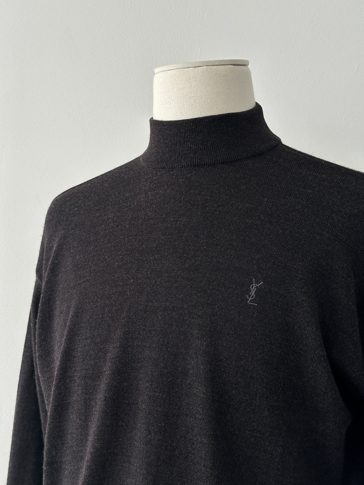 Yves Saint Laurent 1990s wool high-neck jumper in black, featuring a classic high collar and tailored fit, front view.