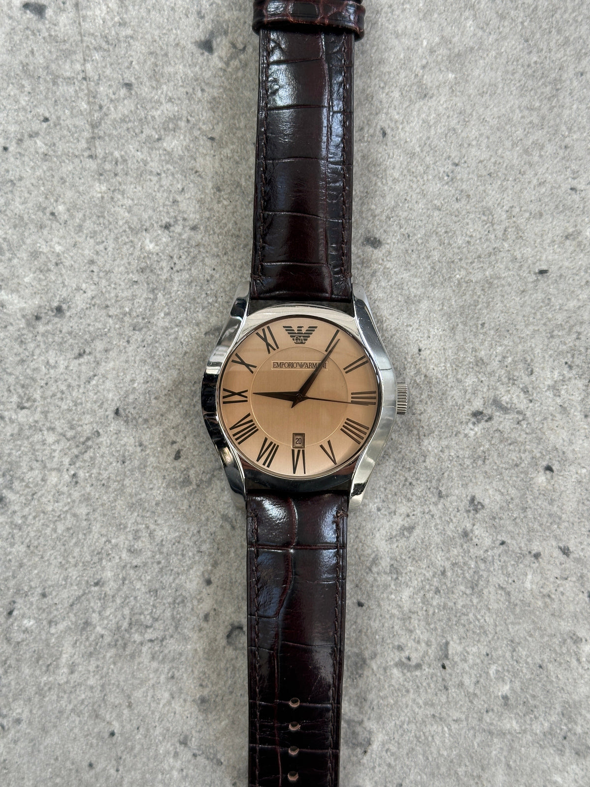 Emporio Armani 2000s leather quartz watch with a sleek round dial and classic design, featuring a leather strap and Armani branding.