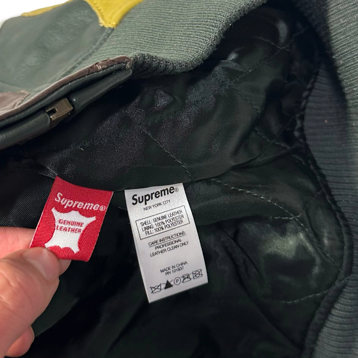 Close-up of the internal care and authenticity labels of a 1036 Emporium leather jacket.