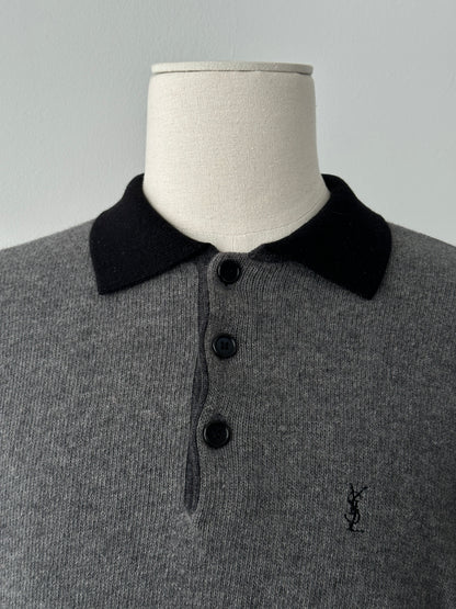 Yves Saint Laurent 1990s wool polo jumper in navy with ribbed collar and cuffs, displayed flat on a neutral background.