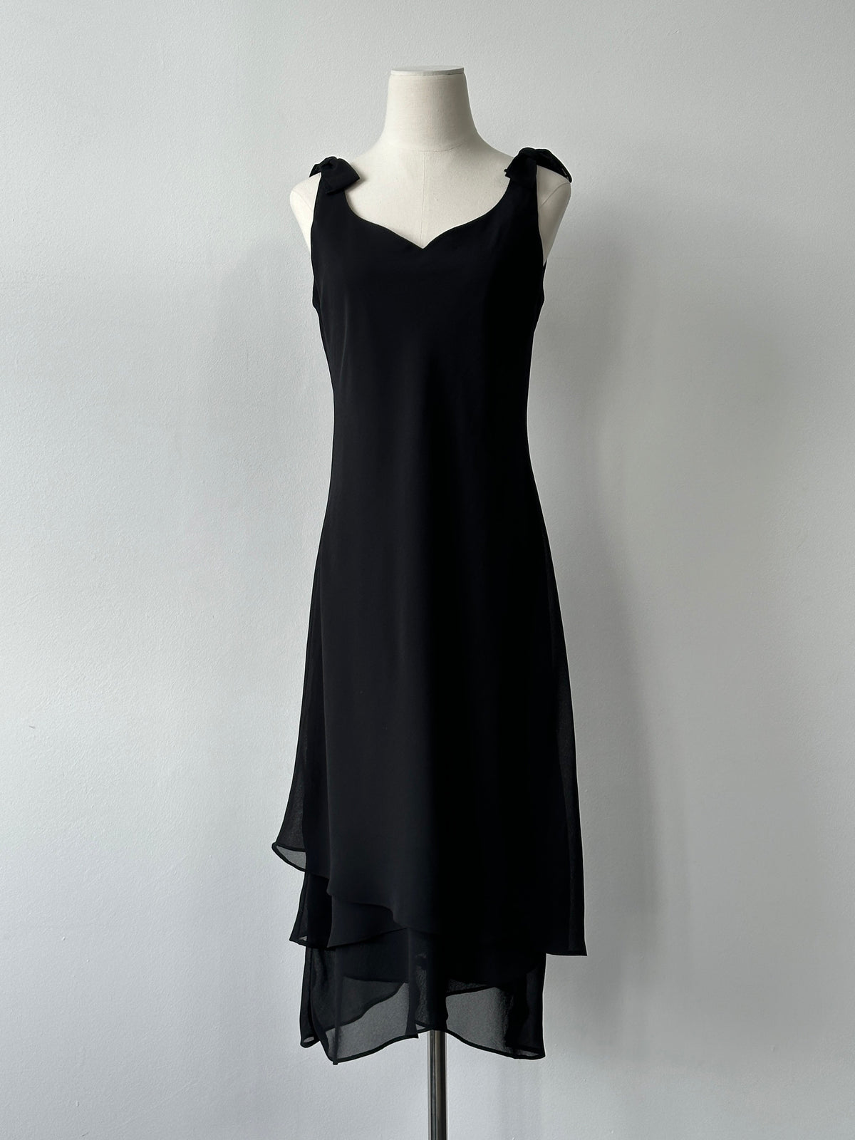 Vintage 1990s layered sleeveless midi dress in size S, featuring a retro style and flowing fabric, shown on a hanger.