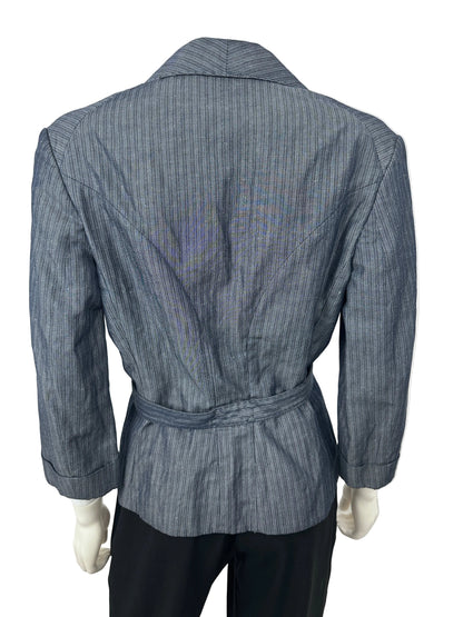 A slate blue pinstriped belted jacket displayed on a mannequin, paired with black trousers, photographed against a plain white background.